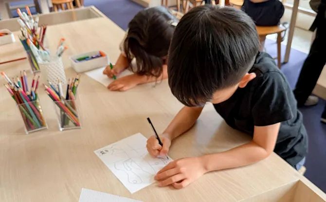Children are immersed in drawing and colouring at one of the many arts experiences in Singapore.