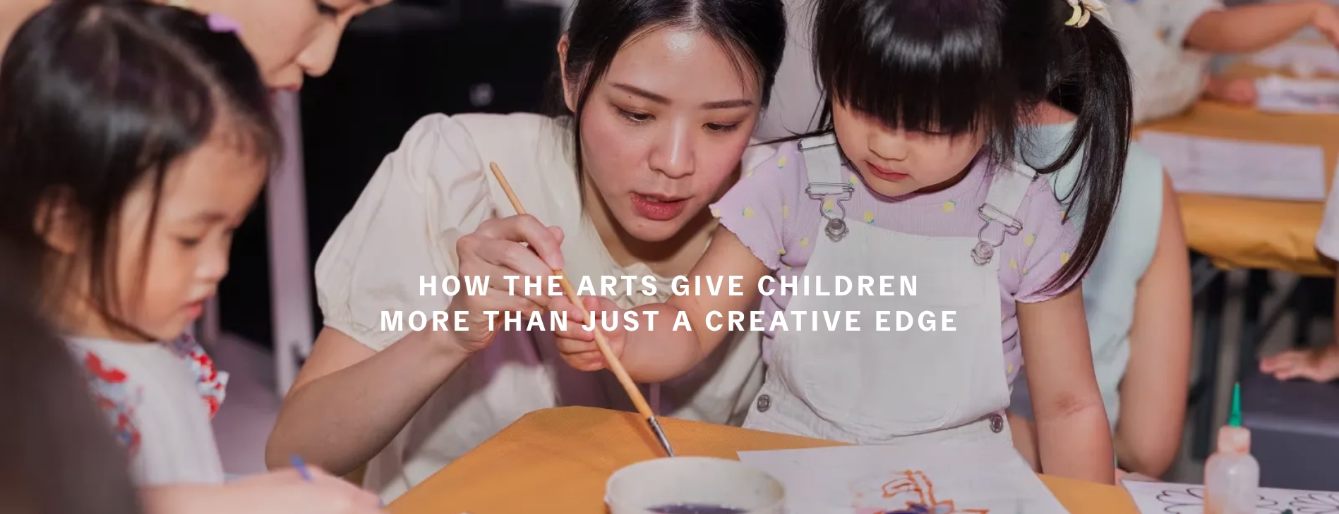 A woman guides a child in painting. A text reads, "How the arts give children more than just a creative edge."