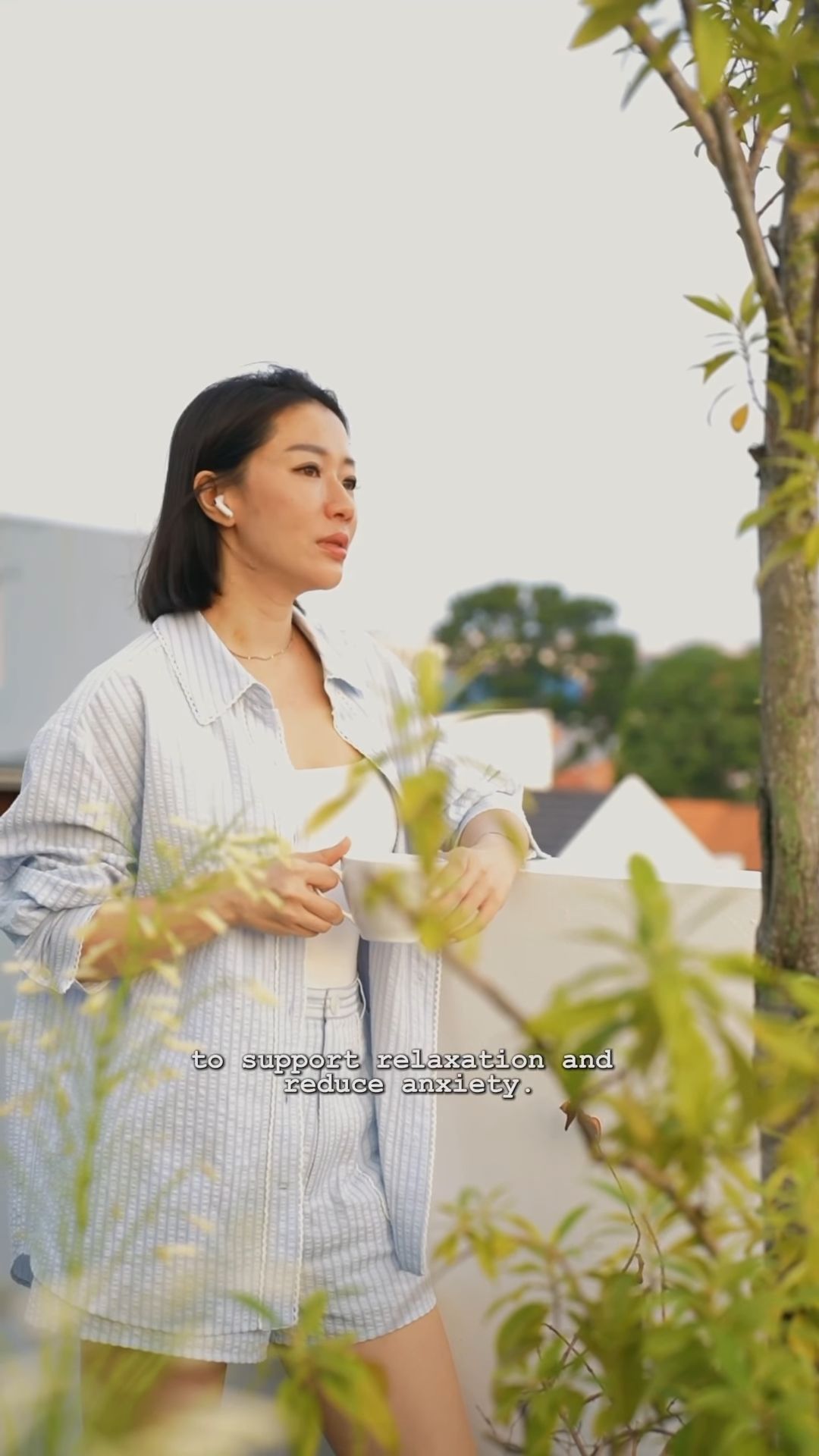 A woman eases into her morning by listening to Teng Company's "Music for Mindfulness". This gives her clarity and energy, starting the day off on the right foot.