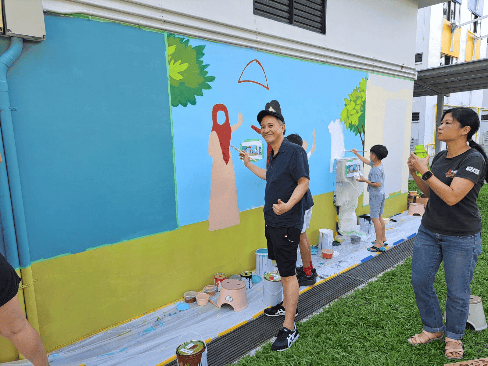Contributors painting mural at HDB