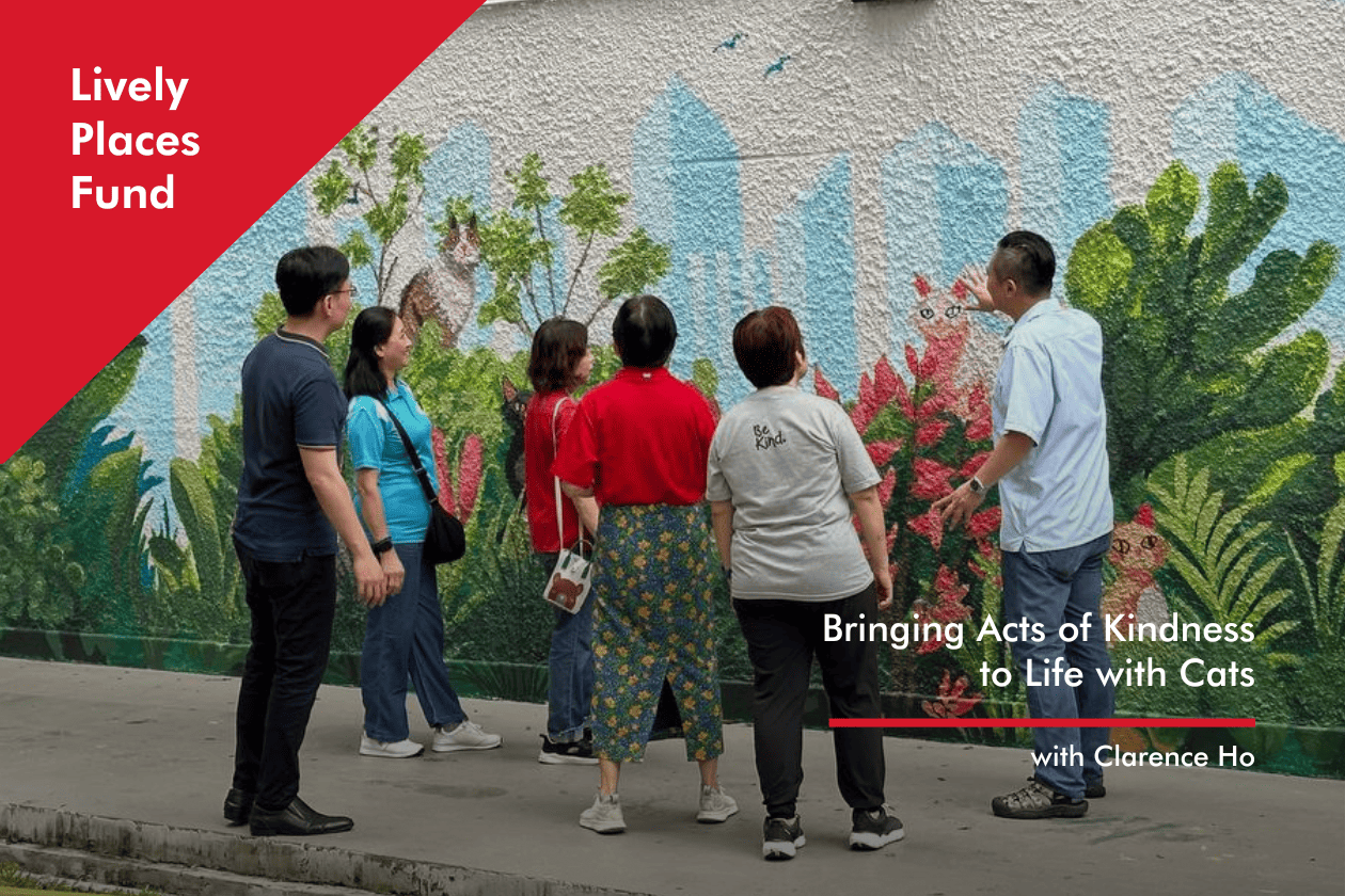 Life with Cats with Clarence Ho Artist Clarence Ho admiring the mural with fellow contributors who worked on 'Cats and Kindness'