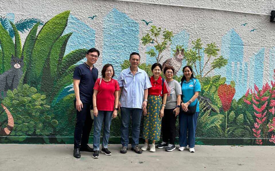 Clarence Ho in blue shirt with contributors