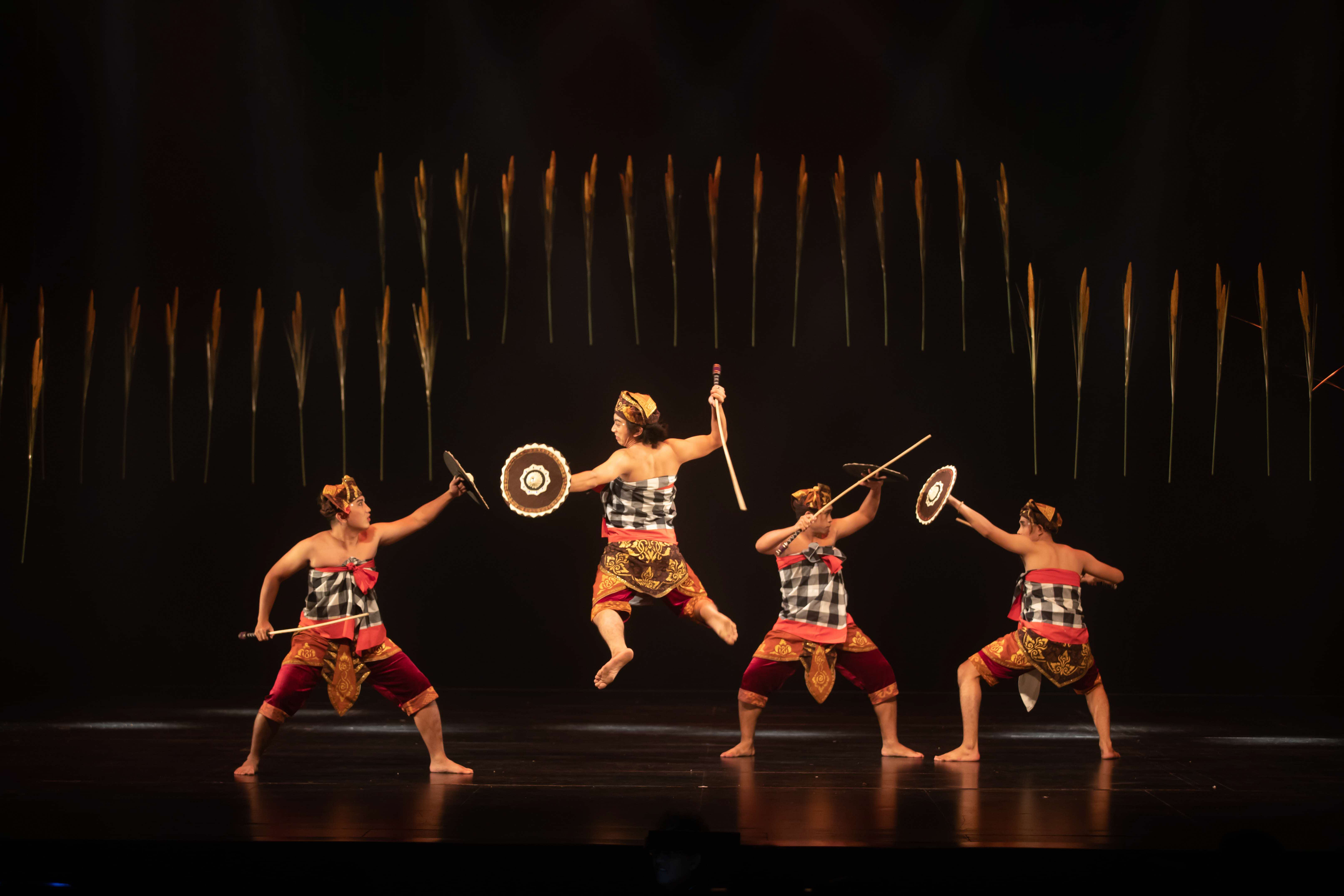 Dancers mid-fight and mid-air for ‘ARISI:Rice’. Four dancers perform a dance in warrior-like poses, mid-fight and mid-air.