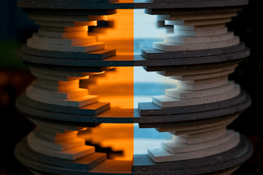 ‘Strata’ at night and in the day Close-up of the sculpture, with a dramatic split down the middle of the image. On the left, a warm orange light emanates from inside out. On the right, cool blue light seeps from inside the sculpture.