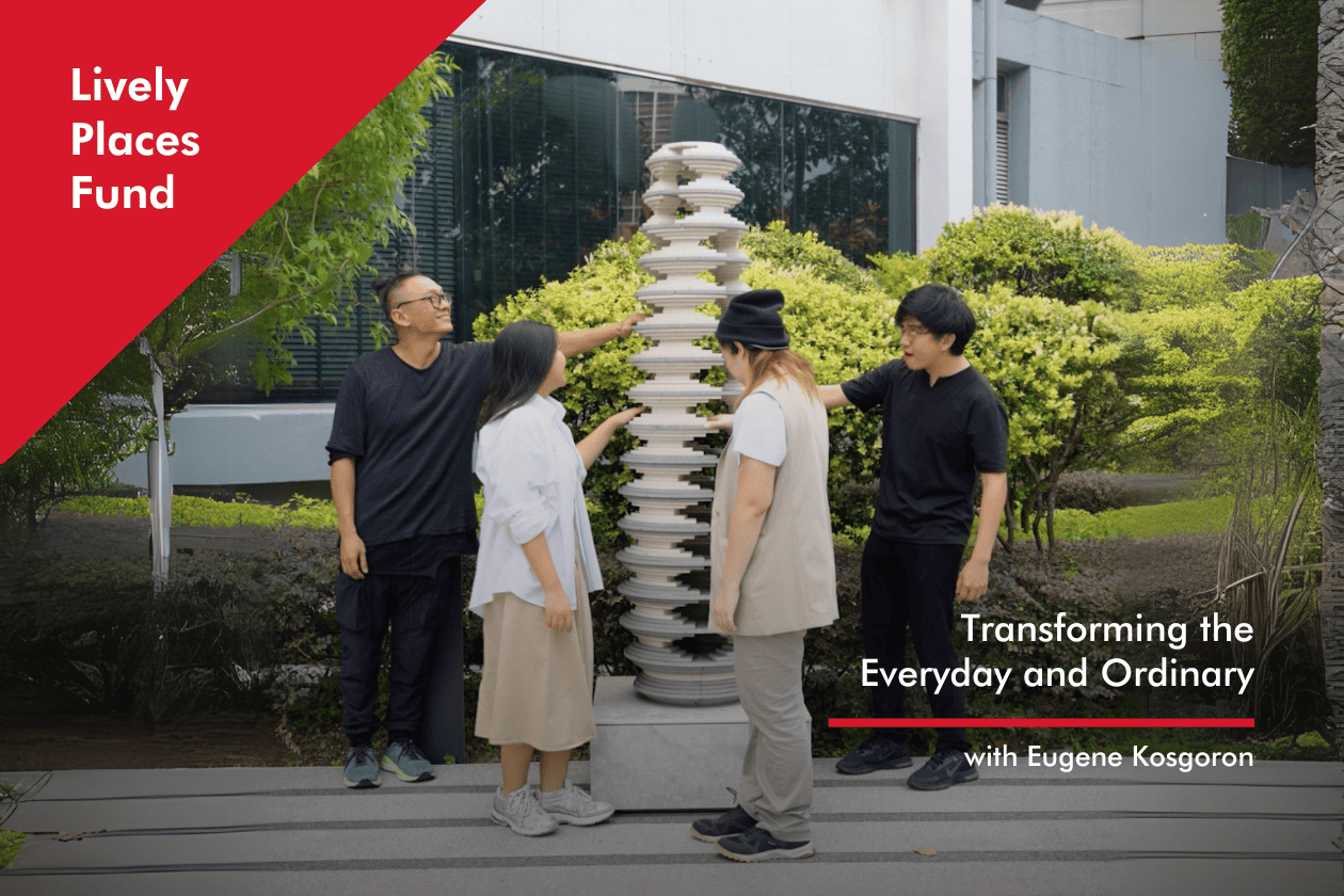 Everyday and Ordinary_Thumbnail Four people stand around a tall, cylindrical sculpture of stacked concrete discs forming an artwork called Strata. The staggered discs create openings, revealing greenery in the background