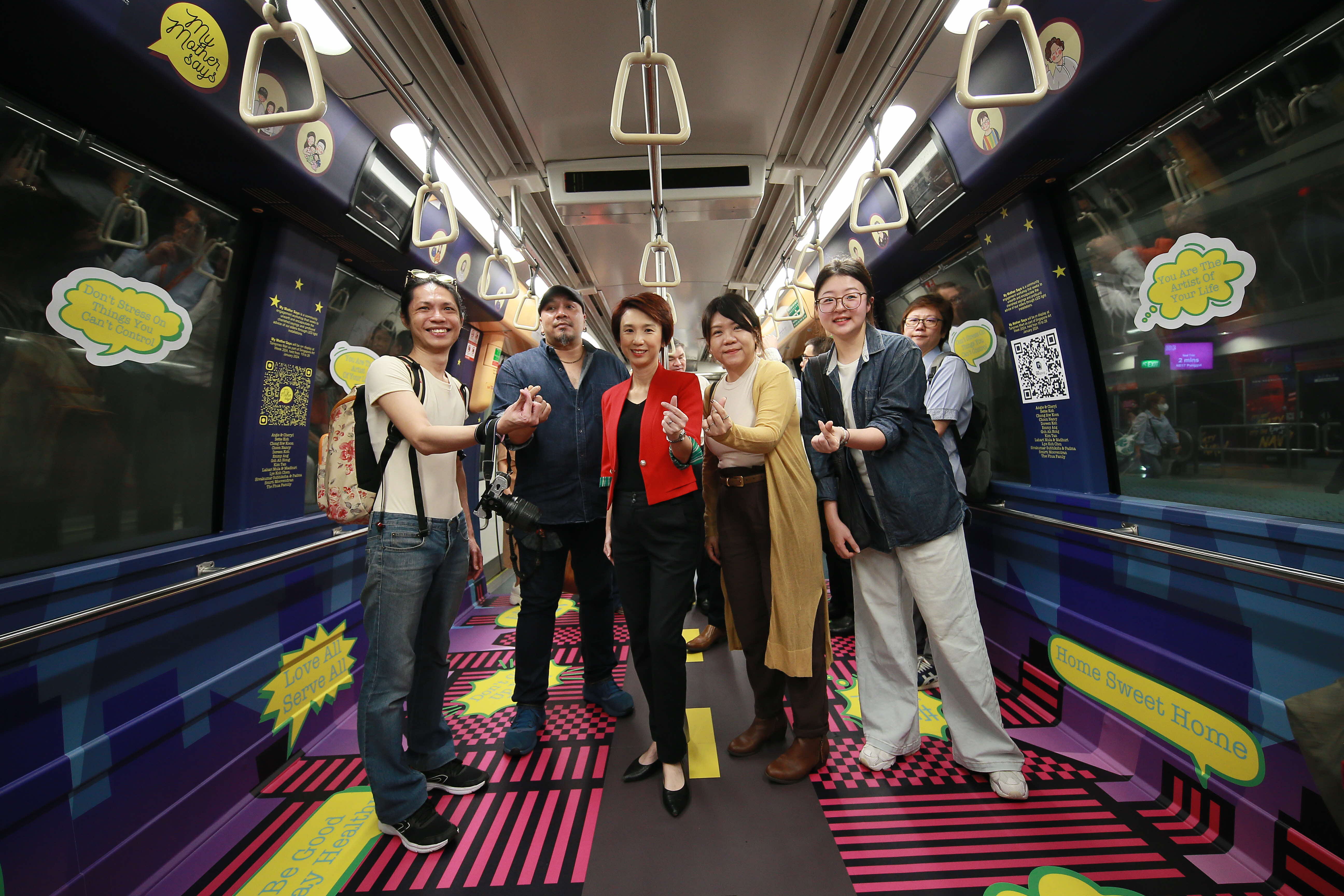 Ms Low Yen Ling, Minister of State, Ministry of Culture, Community and Youth & Ministry of Trade and Industry, with artists behind the  “My Mother Says” art themed train presented by the National Arts Council and the Land Transport Authority.